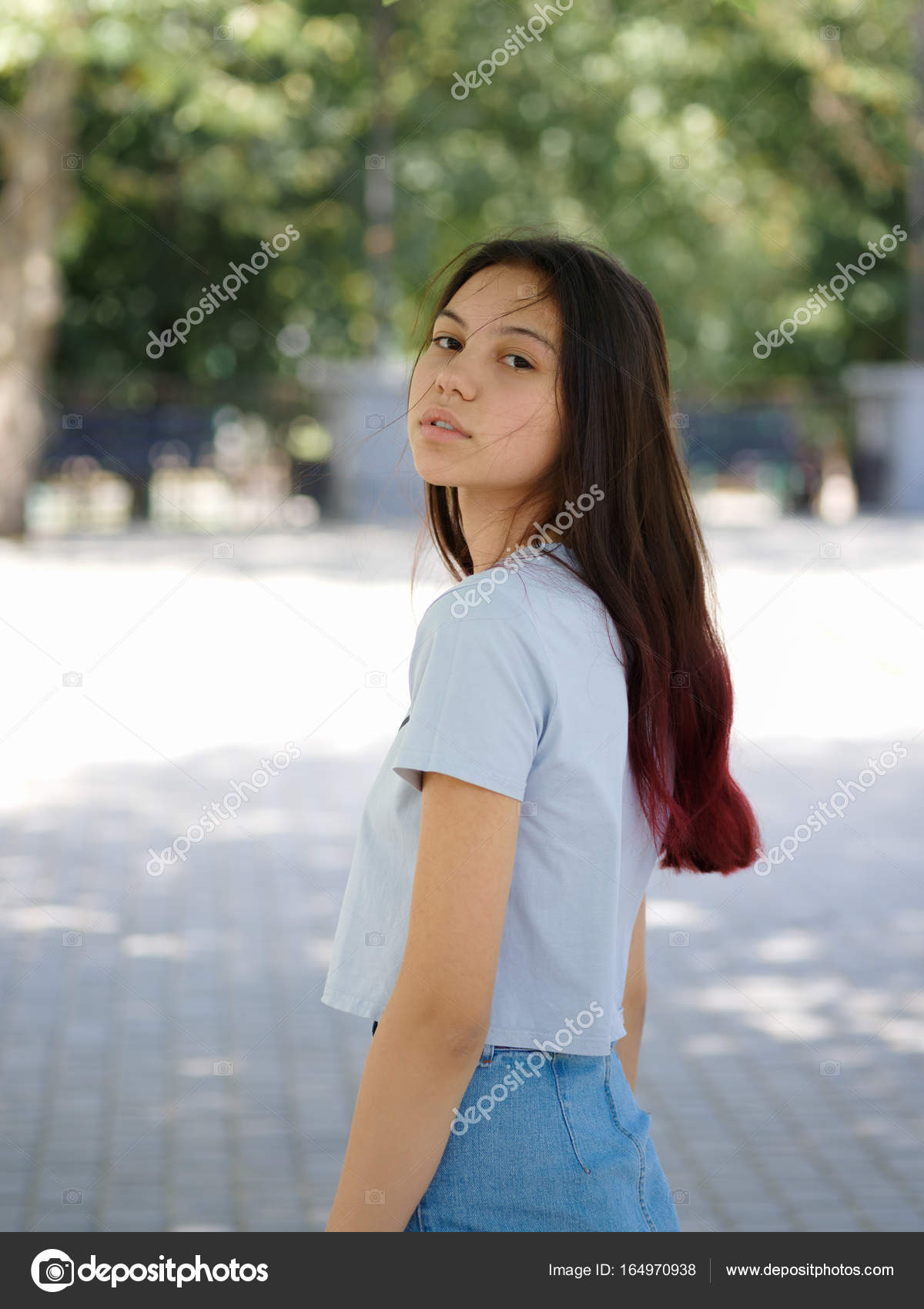 A Fashion Charming Hipster Girl In Casual Clothes Posing On A
