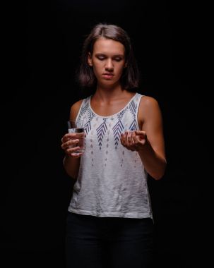 Kadın alarak Antidepresanlar. Bir hastanın hapları siyah bir arka plan ile. Stres, anksiyete, depresyon tedavi kavramı.