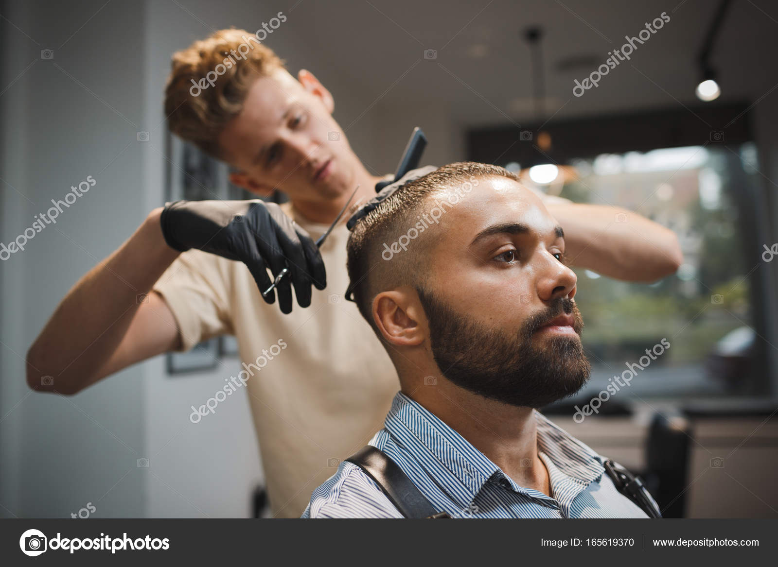 A Handsome Man Is Getting A Haircut By Hairdresser On A Barbershop