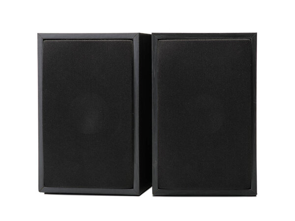 A close-up picture of a couple of black vintage loudspeakers isolated on a white background. Audio equipment for sound quality. Entertainment, technology, music concept.