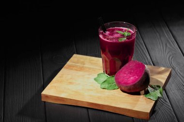 Pancar ve Salatalar ahşap arka plan üzerinde. Bir bardak kırmızı pancar içki kesme masa üzerinde. Vejetaryen Cafe konsept. Kopya alanı.