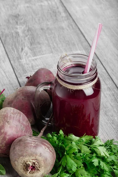 Pancar suyu ahşap arka plan üzerinde bir cam kavanoza. Beetroots ve taze maydanoz kesti. Sebze sallıyor. Kopya alanı.