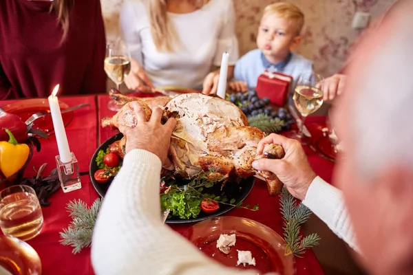 Family eating traditional Thanksgiving turkey on a festive table background. Roasted turkey. Family celebration concept. — Stock Photo, Image