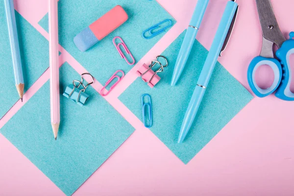 Bir close-up mavi ve pembe ofis parlak pembe bir arka plan üzerinde. Yukarıdan görüntüleyin. Mavi ve pembe ofis. Çok fazla okul nesne.