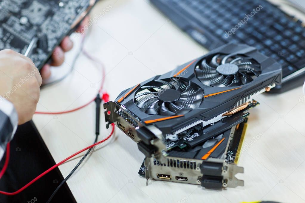 Close-up of a man who repairs a video card. Cryptocurrency. Business and finance concept.