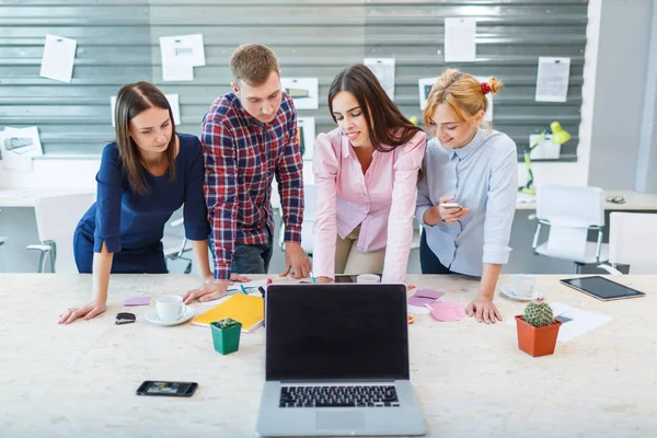 Laptop van de eerste persoon op de achtergrond van een groep van kantoorpersoneel — Stockfoto