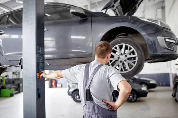 Cars, raised on a car lift in a car service. — Stock Photo, Image