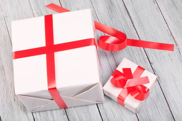 Two white gift boxes on a wooden background Royalty Free Stock Photos