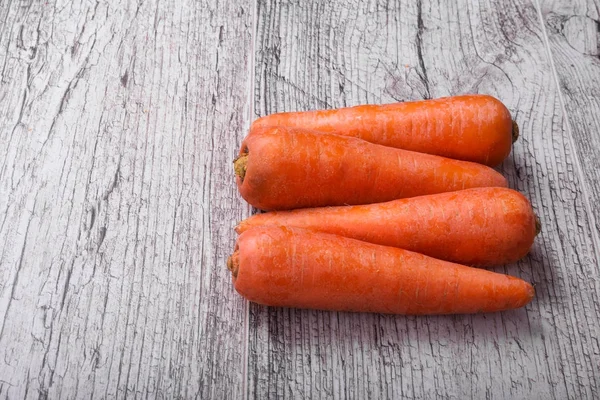 Dört soyulmuş portakal havuç close-up, içecekler sağlıklı diyetler, yemekler, meyve suları, smoothies hafif ahşap arka plan üzerinde karoten ile. Yaz hasat havuç.