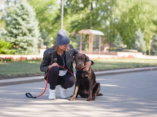 Bir köpek çömelme sırasında bir kız köpeğini hugs