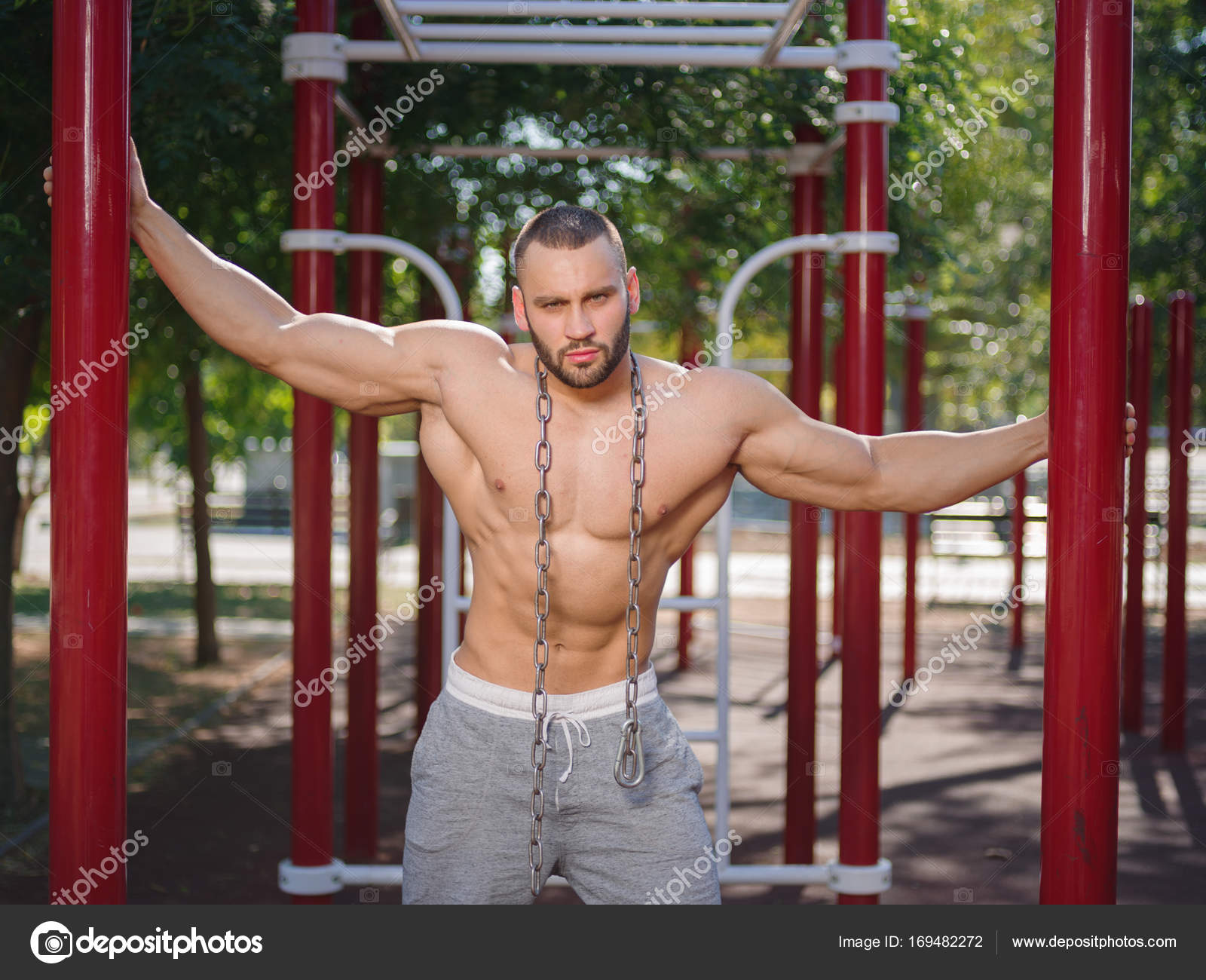 Sexy and muscular shirtless bodybuilder man showing off on a