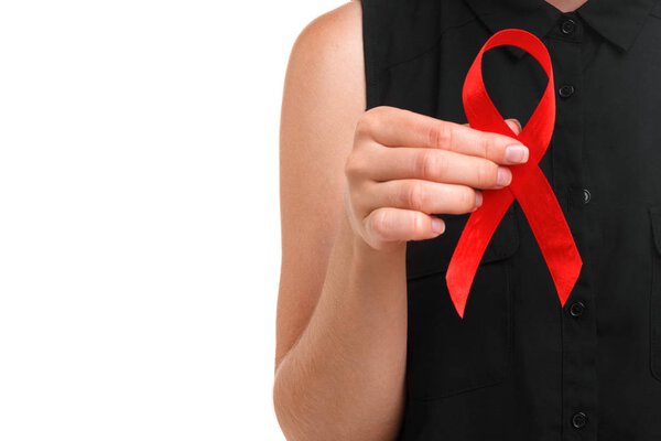 Close-up of a woman showing a bright red ribbon isolated on a white background. A symbol of illegal drugs prevention, and drunk driving danger. Solidarity with people living with AIDS disease.