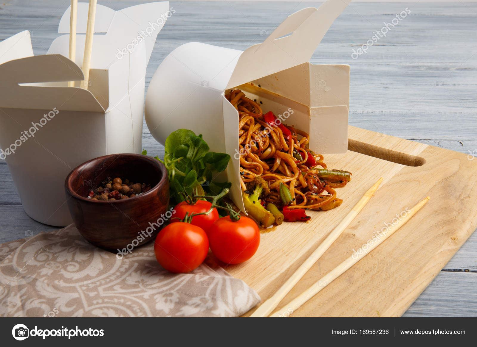 Chinese noodles in a box on a gray table. Stock Photo by ©alfa4studio