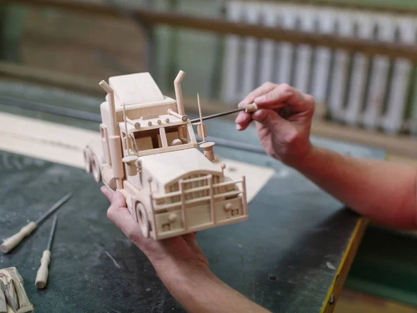 stock image Wooden car close-up with hands of the master