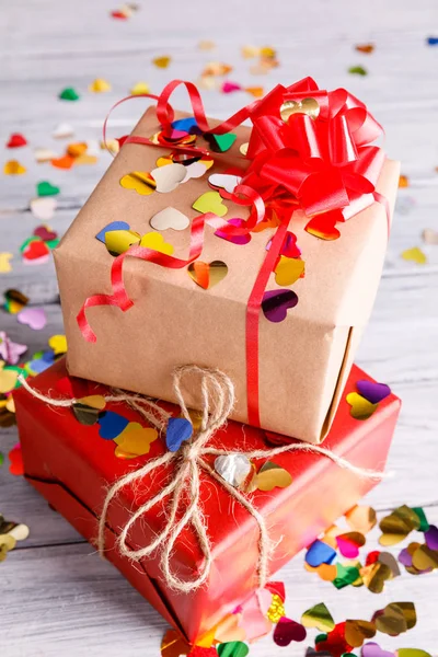 Dos regalos de rojo y blanco sobre un fondo de madera gris — Foto de Stock