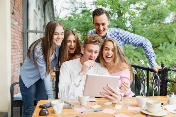 Cheerful friends excited about new tablet at the cafe background. Connection and technology concept. — Stock Photo, Image