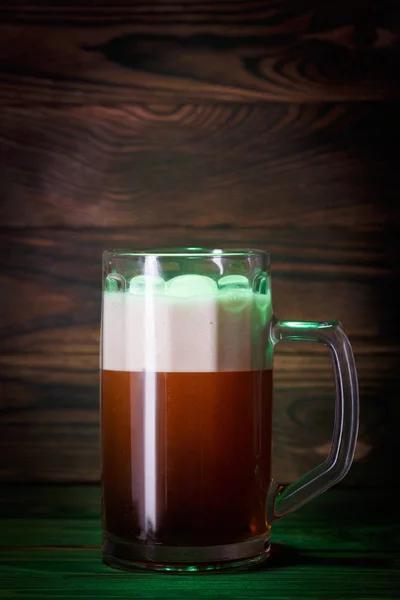 A large glass of dark beer with foam — Stock Photo, Image