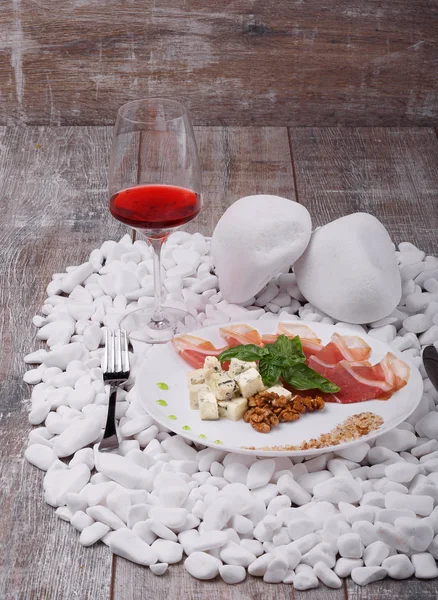Ein Glas Rotwein Und Ein Teller Mit Prosciutto Scheiben Gewürzt — Stockfoto