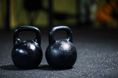 close-up picture of  metal black kettlebells. Sports equipment on a blurred background. clipart