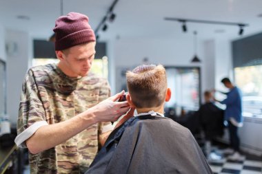 Kuaför berber parihopher strechot küçük oğlan iskemlede