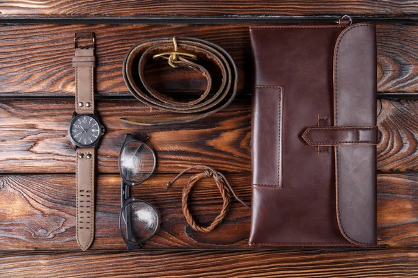 Leather accessories of the photographer on a brown wooden background — Stock Photo, Image