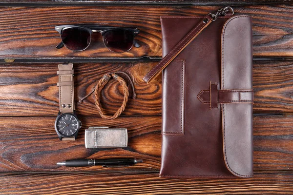 Leather accessories of the photographer on a brown wooden background