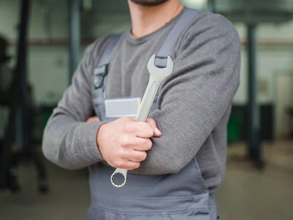 Mechaniker mit Schlüsseln im Arbeitsraum hautnah an der Wand — Stockfoto