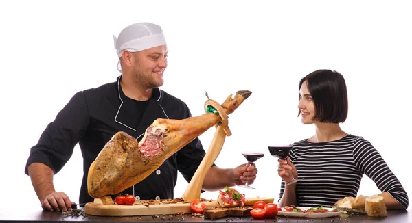 Jamon on a stand close-up on a white isolated background with the cook — Stock Photo, Image