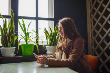 Kafede eğleniyor güzel genç kız.