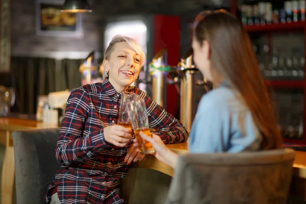 Two young friends having fun in the bar together. Food concept.