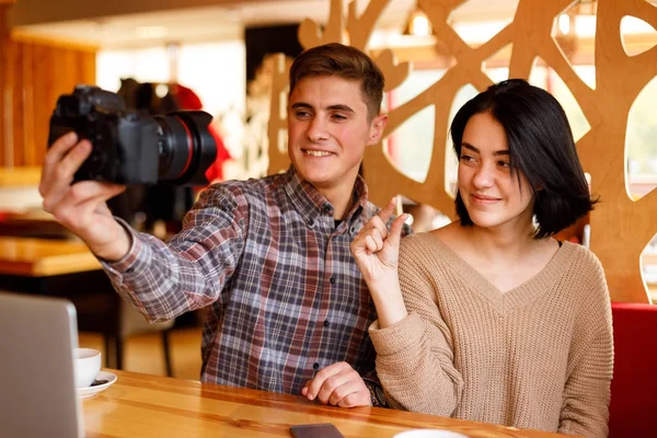 Beautiful couple taking photo in the cafe. — Stock Photo, Image