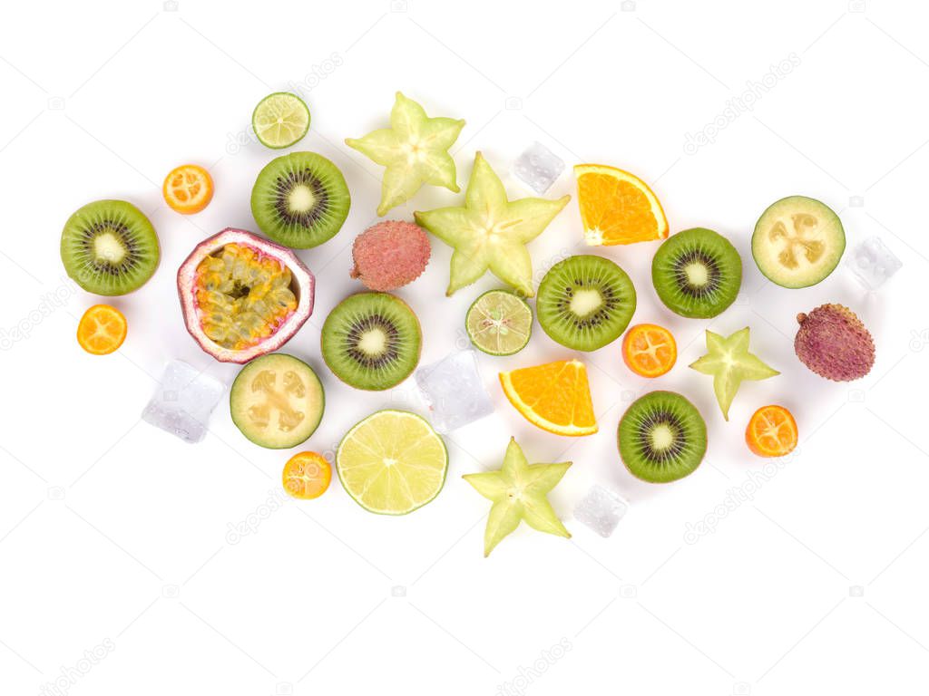 Fresh tropical slices of fruits. Juicy exotic carambolas, oranges, litchi, kiwis, mango isolated on white background.