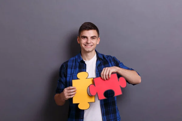 Young Businessman Showing Three Colorful Pieces Jigsaw Puzzle Gray Background — Stock Photo, Image