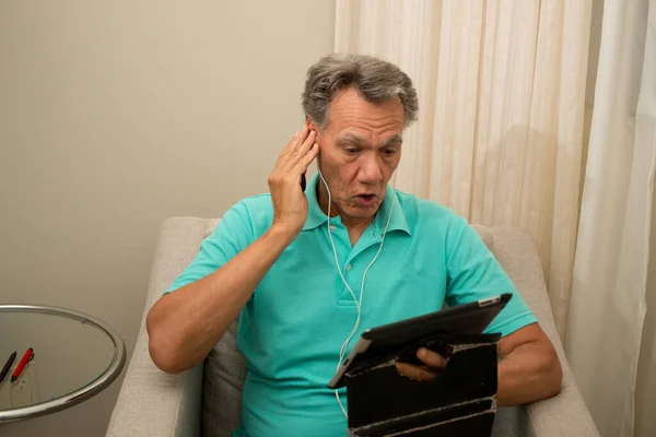 Senior Man Seated Listening News His Smart Table — Stock Photo, Image