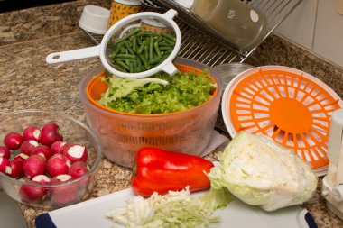 Ingredients for preparing a fresh salad in the kitchen clipart