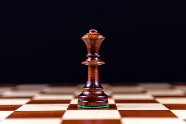 black chess Queen on a black background