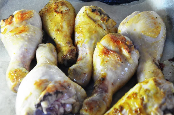 Grilled spicy chicken legs on a black background.Top view. backet chicken on paper