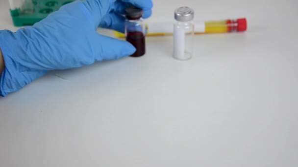 Doctor hands scientist holding ampoule or test tube or vaccine, new medication developing, vaccination against viruses and infections and coronavirus covid 2019 — Stock Video