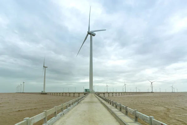 Clean energy, wind power plant with a pathway to the giant wind turbines at sea