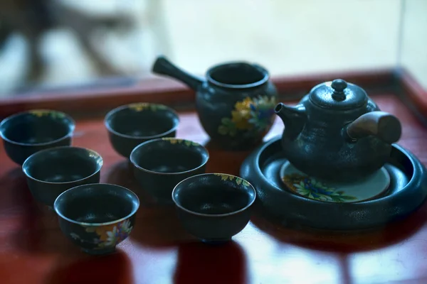 Set of teapots and the old tea cup on the table exhibited as old furniture collection. This is the vestiges of feudal tea art