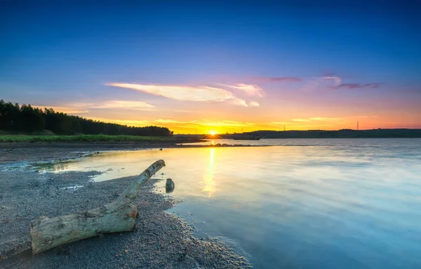 Rays of sunset along river when the sun goes down to the horizon shining the sunshine into the dramatic sky. This rare moment is admired in the sky at the end of day.