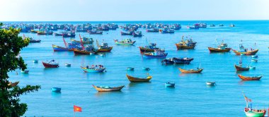 Mui Ne, Vietnam - April 22, 2018: Fishing village and traditional fishing boat with hundreds boats anchored in beautiful stream. This is  bay for boats avoid rainy season storms in Mui Ne, Vietnam clipart