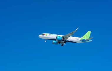 Ho Chi Minh City, Vietnam - December 6th, 2019: Airplane airbus A320 of Bamboo Airways flying through blue sky prepare to landing at Tan Son Nhat International Airport, Ho Chi Minh City, Vietnam