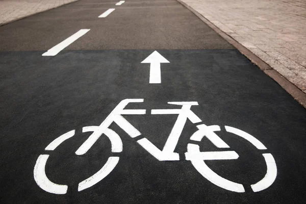 Bicycle white sign or icon on the asphalt road in the city