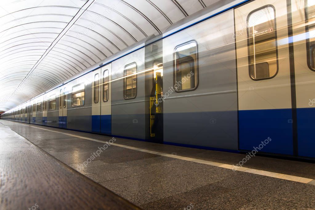 Subway train in motion arriving at station