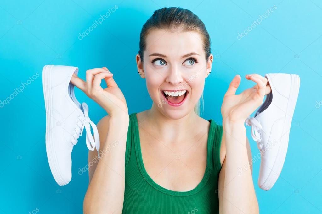 woman holding shoes