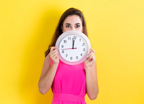 Young Woman hoilding clock — Stock Photo, Image
