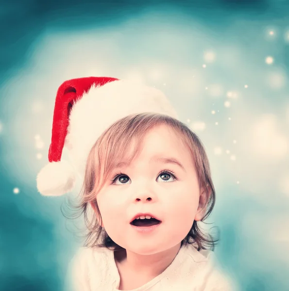 Noel Baba şapkası ile mutlu yürümeye başlayan çocuk kız — Stok fotoğraf
