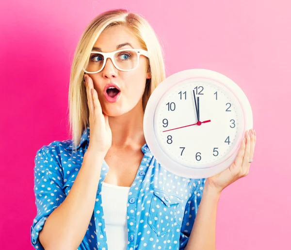 Woman holding clock showing nearly twelve — Stock Photo, Image