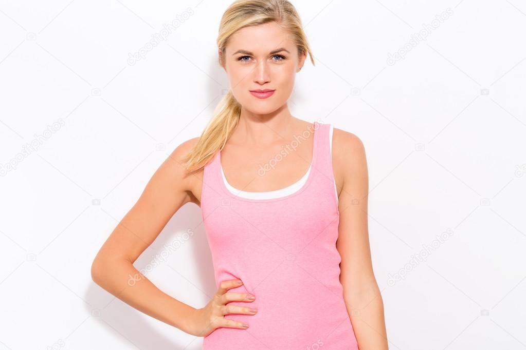 fit woman standing in pink tank-top